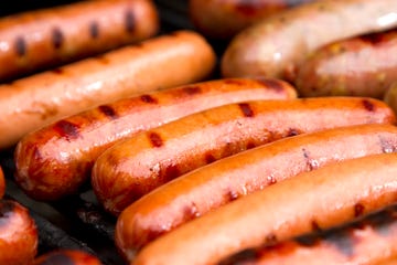 close up of grilled hotdogs on grill