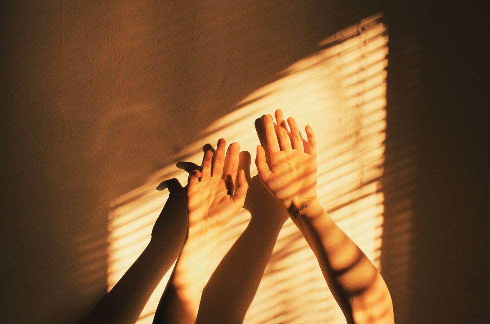 closeup of hands against wall at home
