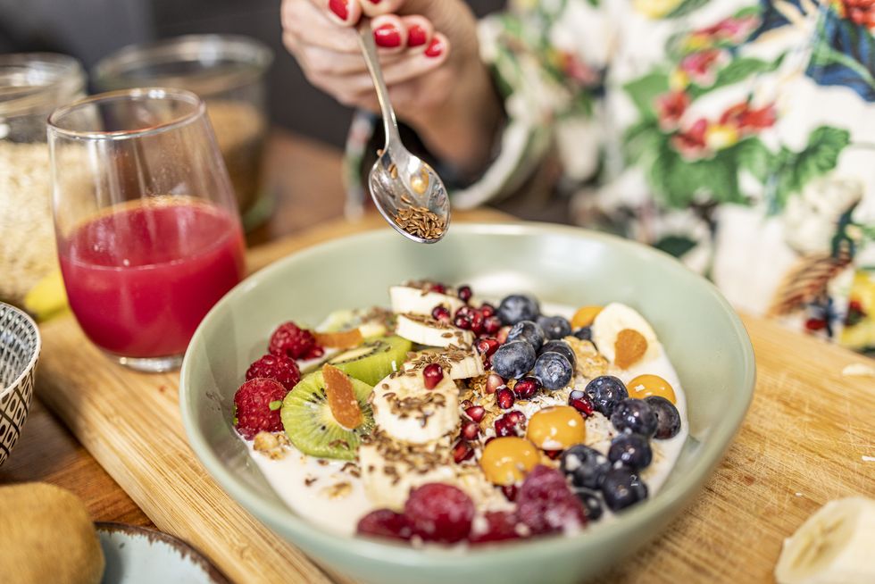 close up of healthy breakfast superfood bowl with yogurt and fruits