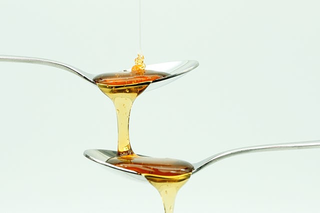 Close-Up Of Honey Against White Background