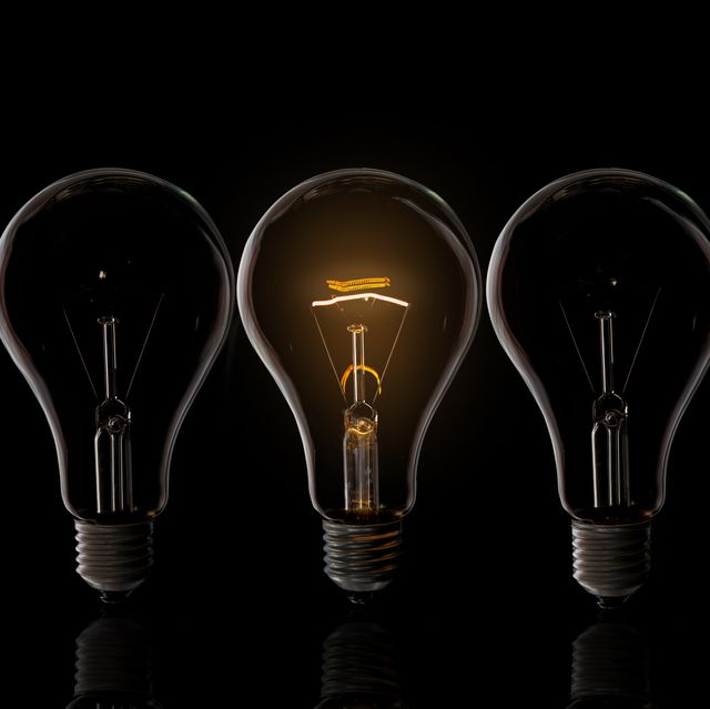 close up of illuminated light bulb against black background
