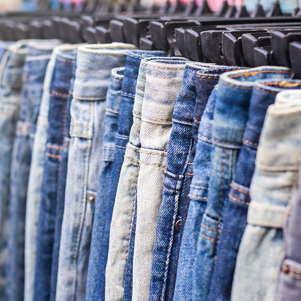 Close-Up Of Jeans Hanging For Sale In Store