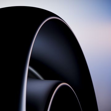 close up of jet engine turbine blades rotating with blurred background