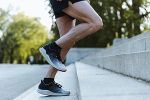 close up of legs of a sporty man training up on the stairs