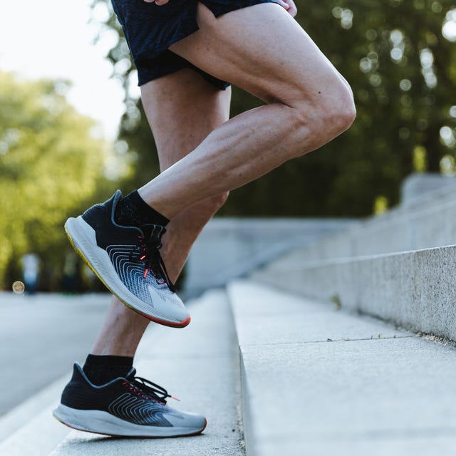 close up of legs of a sporty man training up on the stairs