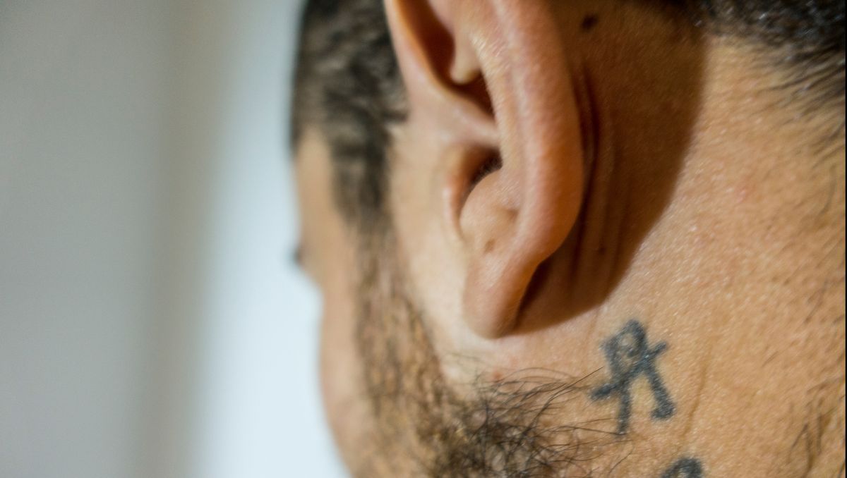 Close-Up Of Man With Tattoo Below Ear
