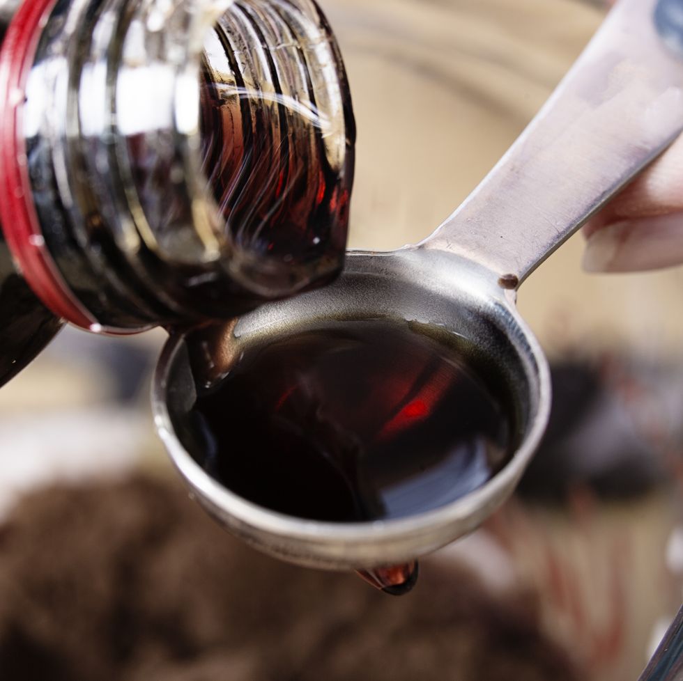 close up of medicine being poured onto a teaspoon