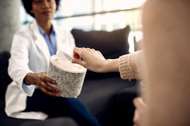 mental health professional offering tissues