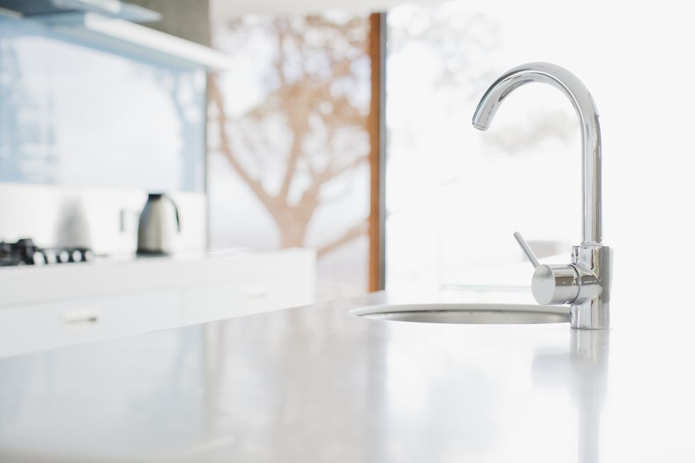 close up of modern kitchen faucet and sink