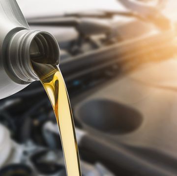 close up of oil pouring in car