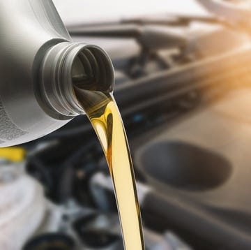 Close-Up Of Oil Pouring In Car