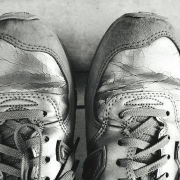 Close-Up Of Old Sports Shoe On Floor