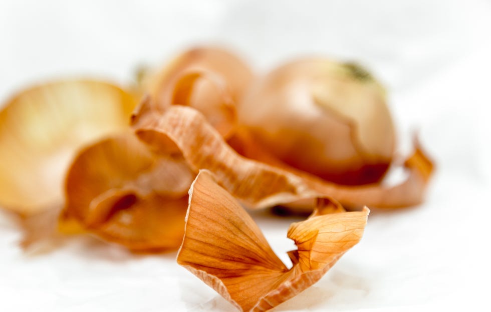 Close-Up Of Onion Peel Over White Background