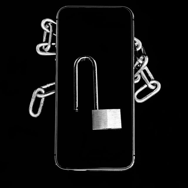 closeup of padlock with chain over black background