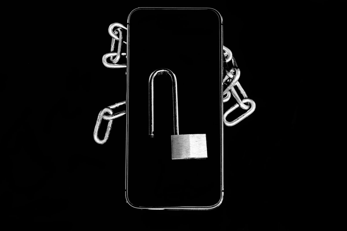 closeup of padlock with chain over black background