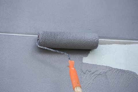 close up of paint roller on wall