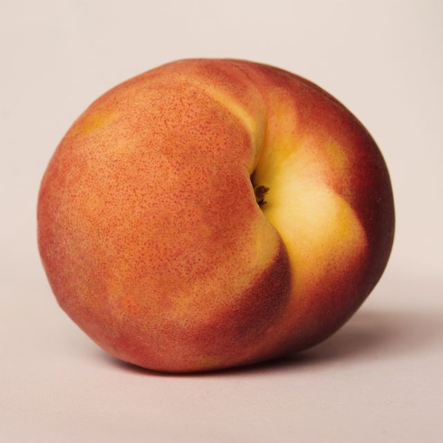 Close-Up Of Peach Over Colored Background