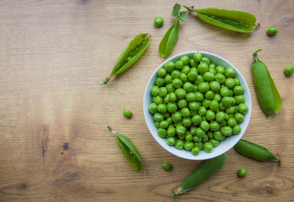 close up of peas in bowl on table