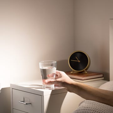 close up of person holding glass on table