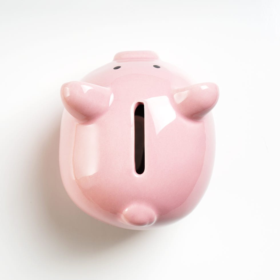 new years resolutions close up of piggy bank on white background