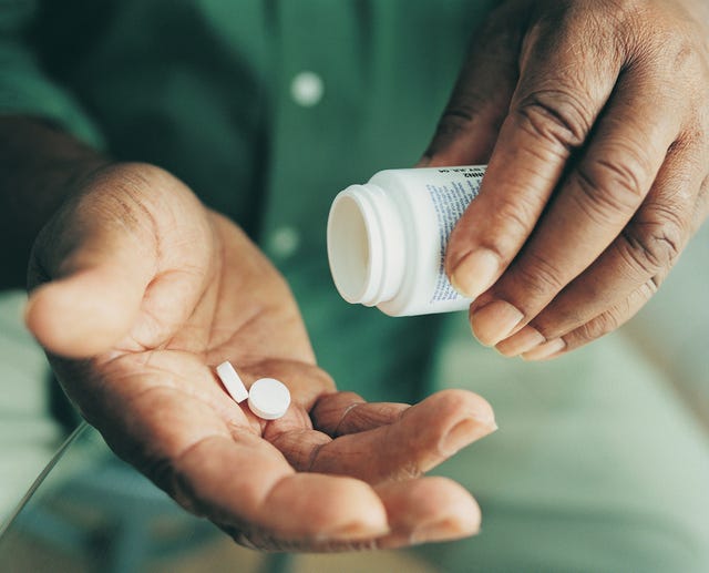 close up of pills being held in someone's hands