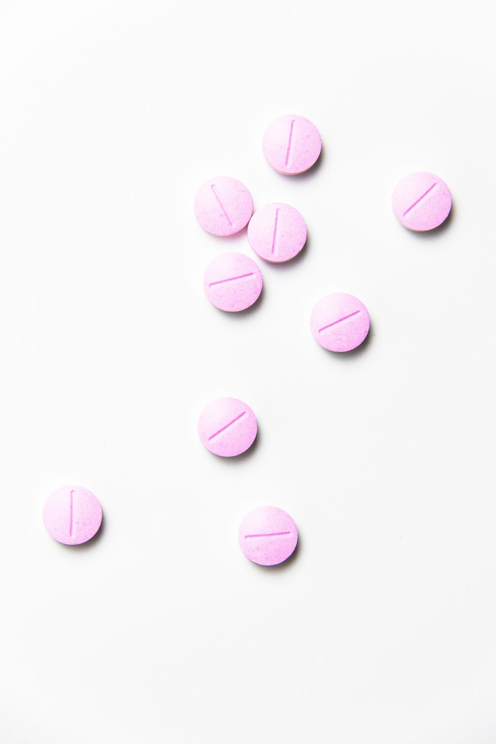 close up of pink medicines over white background