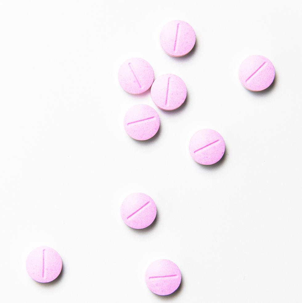close up of pink medicines over white background