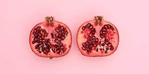 Close-Up Of Pomegranate Slices On Pink Background