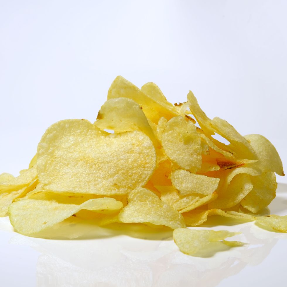 close up of potato chips against white background