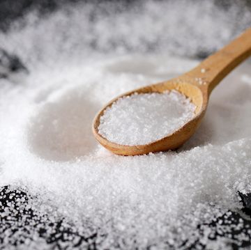 close up of powdered sugar in spoon on table