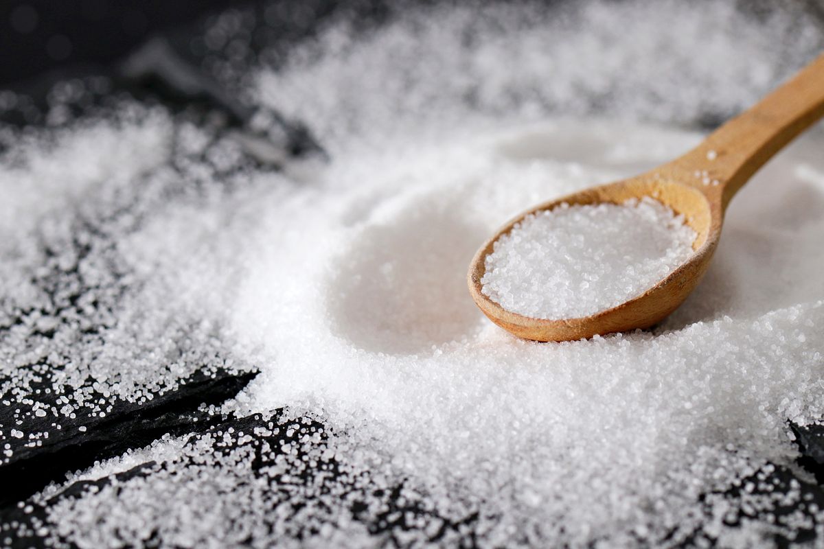 close up of powdered sugar in spoon on table