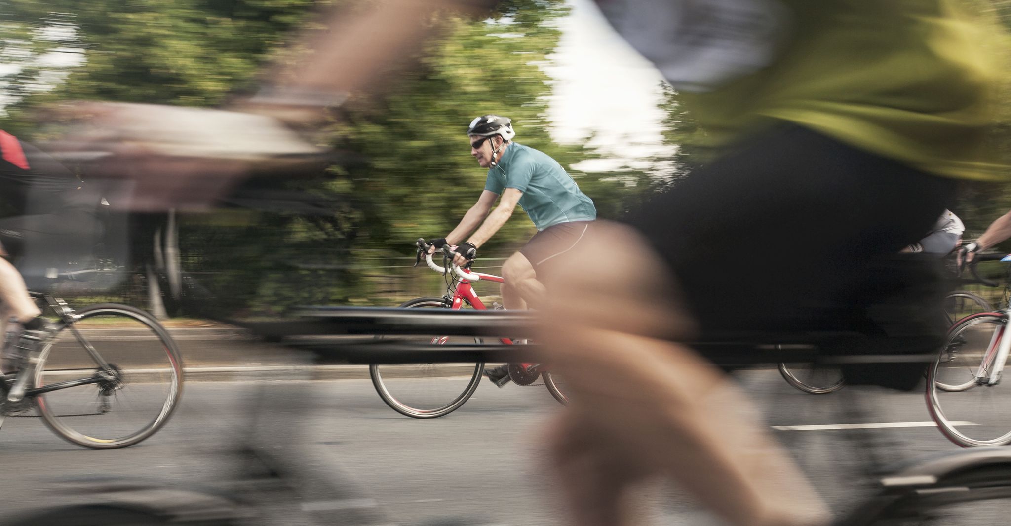 close up of racing cyclists speeding on urban road in racing cycle race
