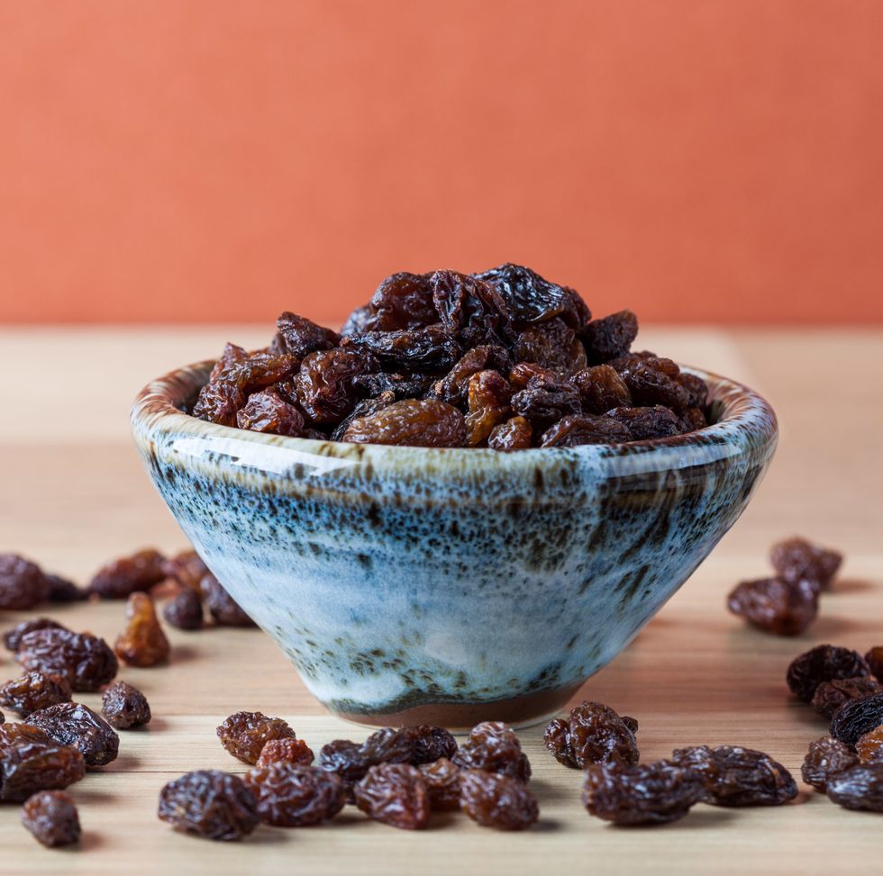 closeup of raisins on wooden table