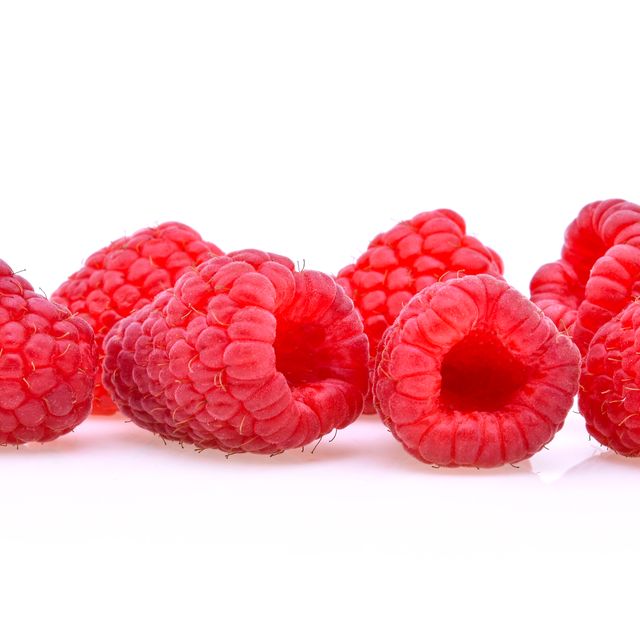 Close-Up Of Raspberries Against White Background
