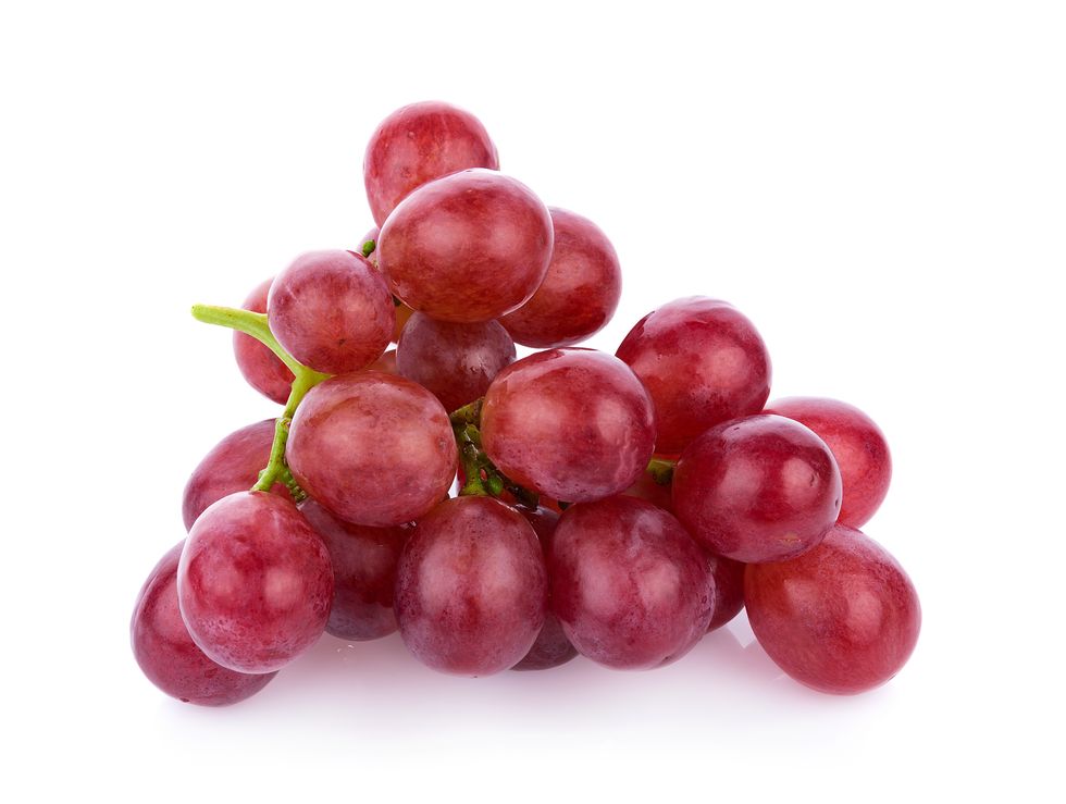 close up of red grapes against white background