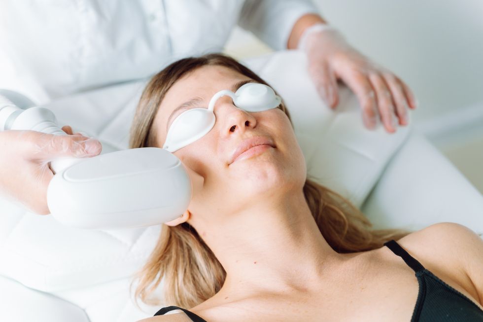 close up of relaxed woman in protect eyeglasses and lingerie lying down on a white couch
