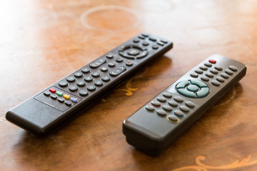 close up of remote controls on table
