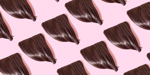 close up of repeated fringes on pink background