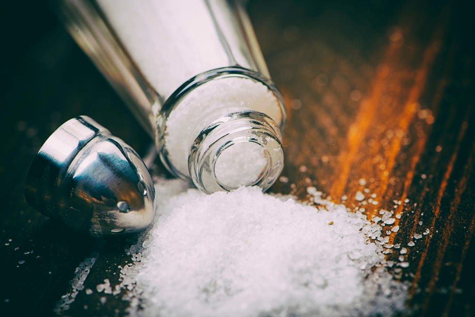 close up of salt shaker spilled on table