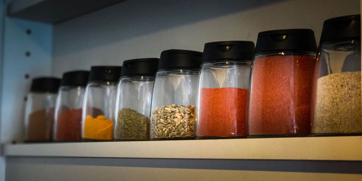 close up of shelf with jars of spices
