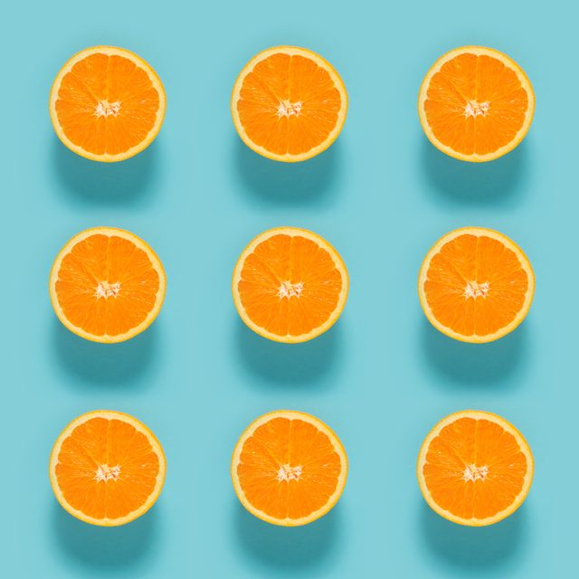 close up of sliced orange fruits on blue background