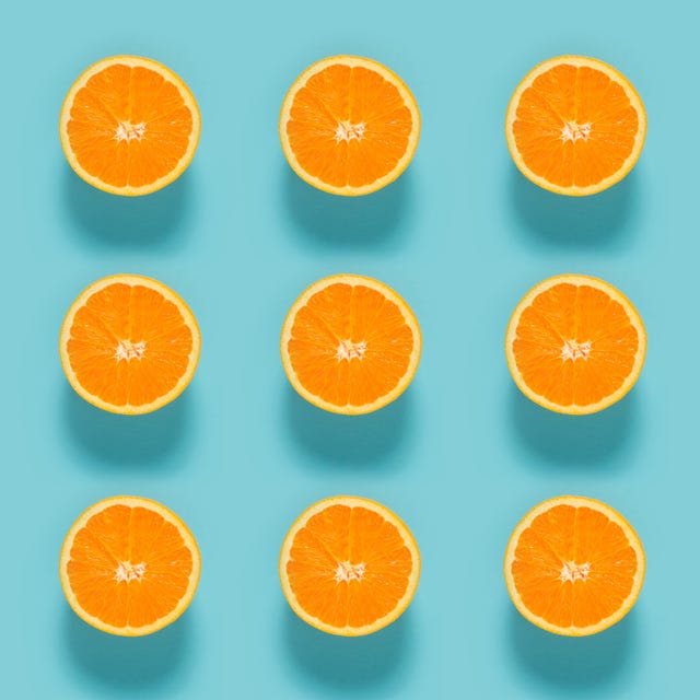 close up of sliced orange fruits on blue background