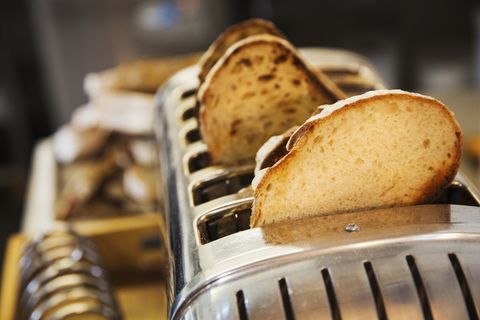 close up of slices of bread in a stainless steel toaster