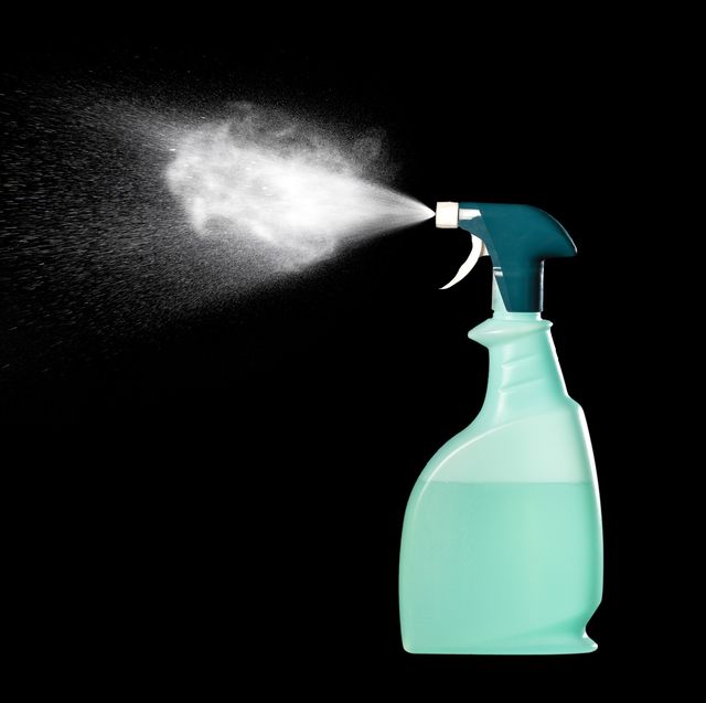 close up of spray bottle with cleaning or disinfectant fluid on a black background