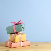 close up of stack gifts on table against blue background