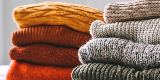 Close-Up Of Sweaters On Bed