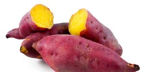 Close-Up Of Sweet Potatoes Against White Background