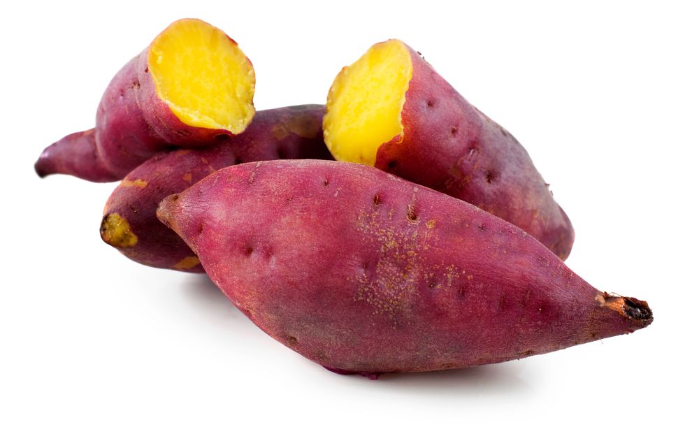close up of sweet potatoes against white background