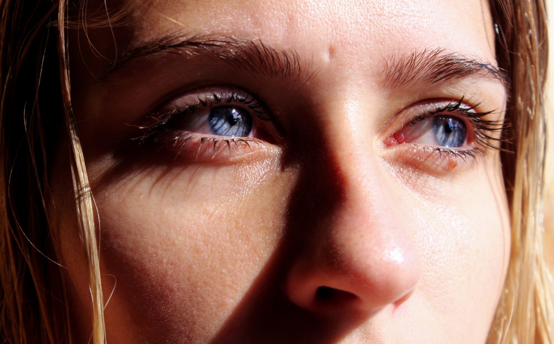 close up of thoughtful young woman with blue eyes