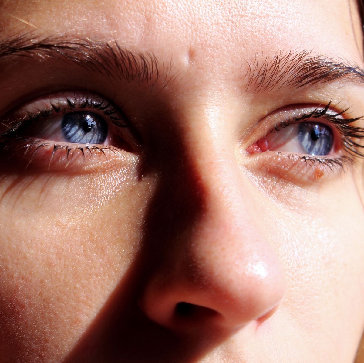 close up of thoughtful young woman with blue eyes